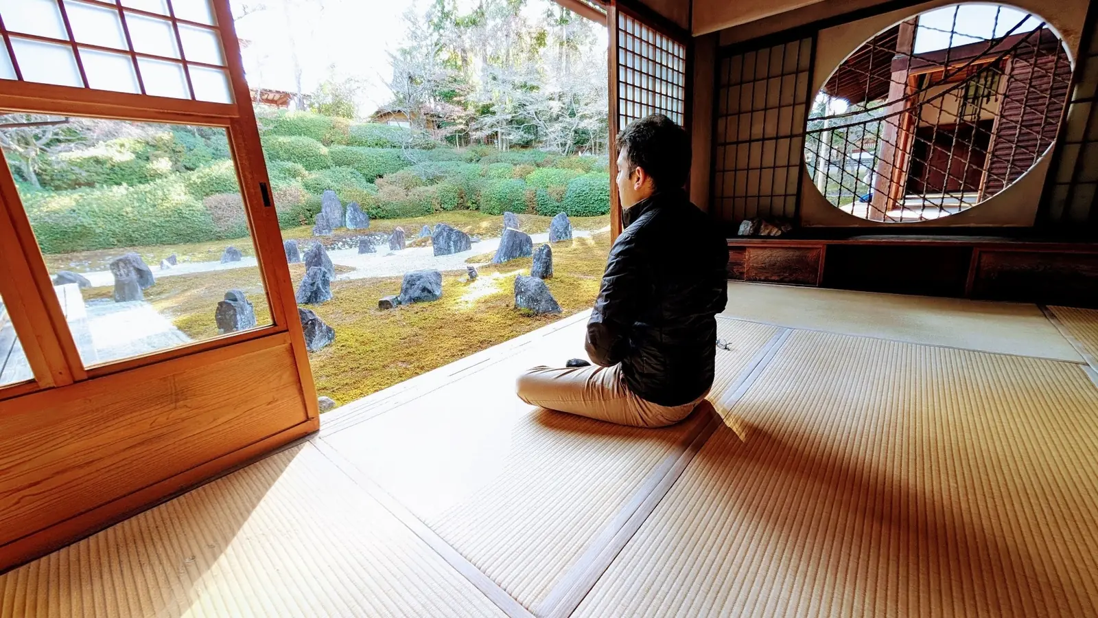 Sameer Vermani seated in quiet reflection before a Kyoto stone garden